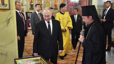 Mr Putin visits the Church of the Holy Life-Giving Trinity, in Pyongyang. EPA