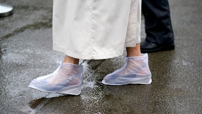 A racegoer wears rain covers on her feet as she arrives for day four of Royal Ascot at Ascot Racecourse. Andrew Matthews/PA Wire.
