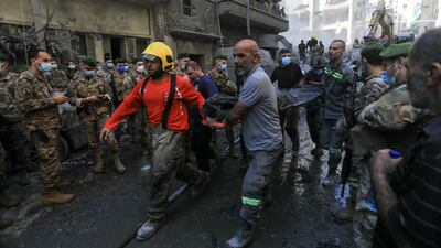 Rescuers remove the body of a person extracted from the rubble of a levelled building, after an Israeli air strike on Beirut’s Basta neighbourhood. AFP