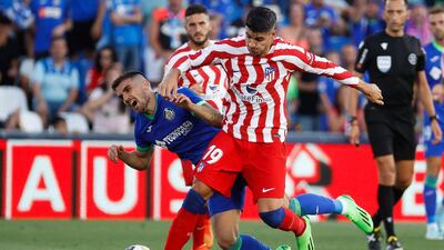 Atletico's Alvaro Morata tangles with Getafe's Mauro Arambarri. EPA