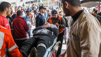 Palestinians wounded in Israeli air strikes arrive at Nasser Hospital. Getty Images
