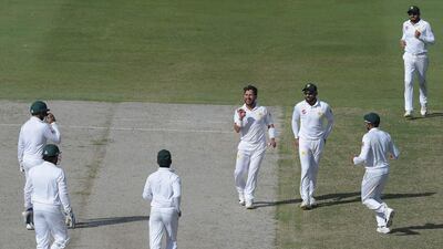 Pakistan leg-spinner Yasir Shah, centre, celebrates with teammates after taking the wicket of New Zealand batsman Ish Sodhi in Dubai on Tuesday. AFP