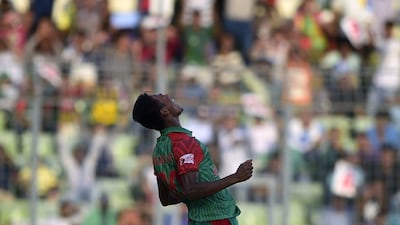 Bangladesh bowler Mustafizur Rahman celebrates after taking the wicket of MS Dhoni on Sunday in his side's ODI victory in Dhaka. Munir uz Zaman / AFP / June 21, 2015