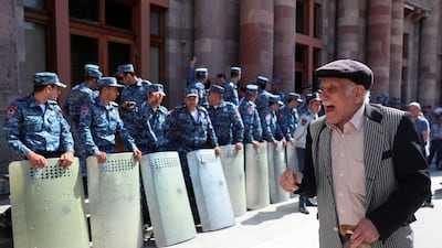 A protester reacts next to law enforcement officers during a gathering outside the government building following the launch of a military operation by Azerbaijani forces in the region of Nagorno-Karabakh in Yerevan, Armenia. Reuters