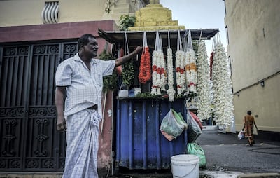 Navaratnam, a Tamil flower garland seller, looks out to the street in Bambalapitiya, Colombo. Jack Moore/The National