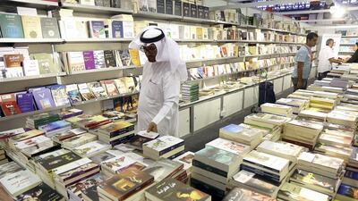 A visitor takes a look at the books during the Sharjah International Book Fair at the Sharjah Expo Centre in Sharjah. Satish Kumar for the National