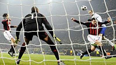 Manchester United's Wayne Rooney scores his first header against AC Milan at the San Siro on Tuesday night in front of 78,000 fans.
