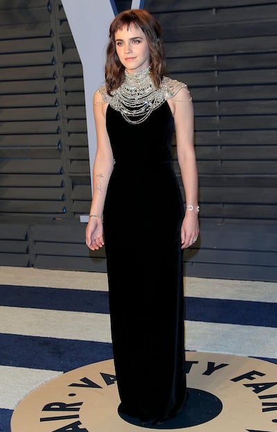 Emma Watson poses at the 2018 Vanity Fair Oscar Party following the 90th annual Academy Awards ceremony with a grammatically incorrect temporary tattoo. EPA