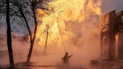 Firefighters work to extinguish a blaze near a car dealership after a missile strike in Kyiv, Ukraine, in January 2024. EPA