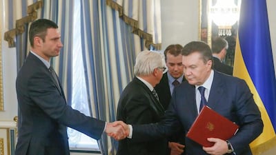 Ukrainian President Viktor Yanukovich and opposition leader Vitali Klitschko shake hands after signing the agreement in the Presidential Palace in Kiev on Friday. Sergey Dolzhenko / EPA