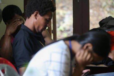 Relatives listen to an update on the mission to rescue 12 boys and their soccer coach from a flooded cave complex in northern Thailand on July 6, 2018. Athit Perawongmetha / Reuters