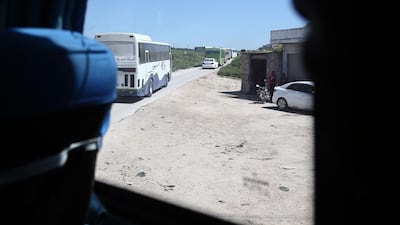 A convoy transporting Syrian civilians and rebel fighters drives in Arbin in Eastern Ghouta as they are evacuated from the opposition enclave to the village of Qalaat al-Madiq, some 45 kilometres northwest of the central city of Hama, on March 26, 2018. Abdulmonam Eassa / AFP