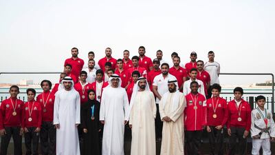 Sheikh Mohammed bin Rashid, Vice President and Ruler of Dubai, Sheikh Mohammed bin Zayed, Crown Prince of Abu Dhabi and Deputy Supreme Commander of the Armed Forces, Sheikh Hamdan bin Mohammed, Crown Prince of Dubai, and Sheikh Tahnoon bin Mohammed, Ruler’s Representative of the Eastern Region of Abu Dhabi, stand for a photograph with UAE jiu-jitsu champions during a Sea Palace barza on Monday. Ryan Carter / Crown Prince Court — Abu Dhabi