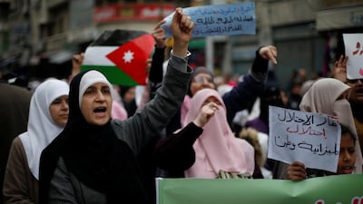 Demonstrators hold Jordanian national flag and chant slogans during a protest against a government's agreement to import natural gas from Israel, in Amman, Jordan. Reuters