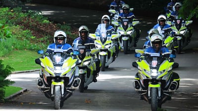 Police officers secure an official convoy. AFP