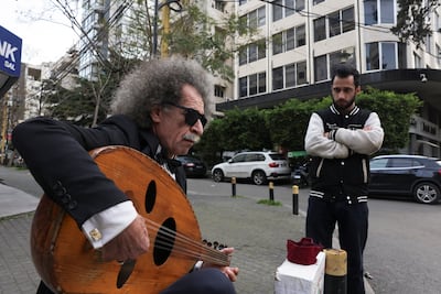 Abed Sabagh, 68, an oud player displaced by Israeli air strikes, plays on a Beirut street on Tuesday. Despite strained resources, many Lebanese are accepting internally displaced citizens into their homes and neighbourhoods. Reuters