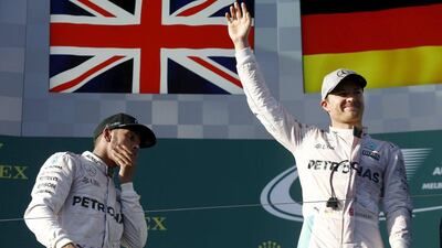 Mercedes F1 driver Nico Rosberg (R) celebrates his win at the Australian Grand Prix alongside second-placed teammate Lewis Hamilton in Melbourne. REUTERS/Jason Reed