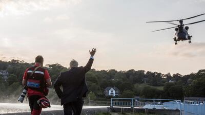 British Prime Minister Boris Johnson (R) waving towards a military Chinook helicopter in Whaley Bridge, Derbyshire. EPA