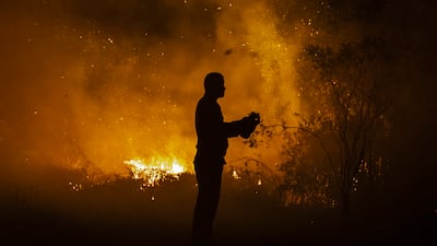 A firefighter tries to extinguish a wildfire on burned peatland and fields on September 23 in South Sumatra, Indonesia. Developing nations with a minimal carbon footprint have for years been bearing the brunt of increasing temperatures, extreme weather and rising sea levels. Getty