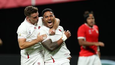 Manu Tuilagi, right, celebrates with teammate George Ford after scoring his second try against Tonga in the Rugby World Cup Group C clash in Japan. Getty