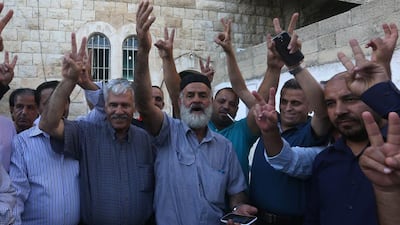 Palestinian Naser Al Deen Allan (C), the father of prisoner Mohammed Allan who is being held by Israel without trial, celebrates with friends following news of his son's temporary release from detention at the family home in the West Bank city of Nablus on August 19, 2015. Jaafar Ashtiyeh/AFP Photo