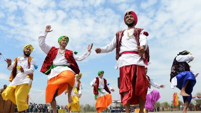 Indian Border Security Force Soldiers (BSF) dance as they celebrate during the Holi festival inside a camp in Srinagar on March 27, 2013. Holi, also called the Festival of Colours, is a popular Hindu spring festival observed in India at the end of the winter season on the last full moon day of the lunar month. AFP PHOTO/Tauseef MUSTAFA *** Local Caption *** 788689-01-08.jpg