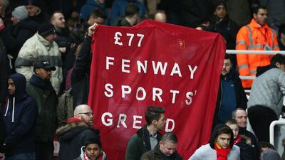 Liverpool fans hold up a sign in protest against ticket prices. (Reuters/Matthew Childs)