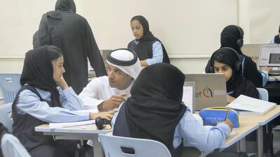Sheikh Hazza bin Zayed speaks with a student during a visit to Al Asayel Primary School. Mohamed Al Hammadi / Crown Prince Court - Abu Dhabi