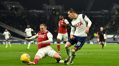 Arsenal's Rob Holding, left, attempts to block the cross from Tottenham Hotspur's Giovani Lo Celso. PA