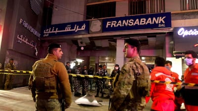Lebanese security forces guard the entrance of a Fransabank branch in the southern city of Saida that was attacked with an explosive device on April 25, 2020. AFP