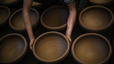 Clay bowls are carefully placed for drying at Sid Atallah's workshop in the central Gaza Strip. AFP