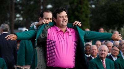 Sergio Garcia of Spain, last year's Masters' champion, helps put the Green Jacket on 2018 Masters winner Patrick Reed. REUTERS/Jonathan Ernst