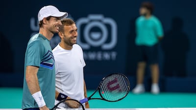 Daniel Evans and Any Murray at the net before their match at the Mubadala World Tennis Championship. Victor Besa / The National