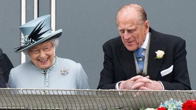 Britain's Queen Elizabeth II reacts as she speaks to Prince Philip on the Queen's Stand during the Epsom Derby Day on Saturday. EPA