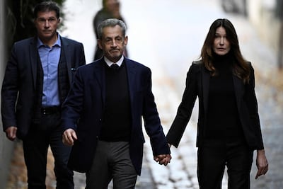 Nicolas Sarkozy, France's former president from 2007 to 2012, walked hand in hand with his wife Carla Bruni-Sarkozy, as he presented himself at La Sante Prison, Paris, in October. AFP
