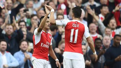 Alexis Sanchez, left, and Mesut Ozil were both in fine form to help Arsenal to victory against Manchester United. Dylan Martinez / Reuters