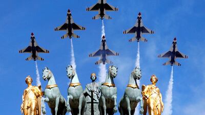 The US Air Force Thunderbirds fly over the Arc de Triomphe during the Bastille Day military parade in Paris. Philippe Wojazer / Reuters