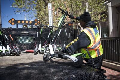 A City of San Francisco Public Works employee loads a LimeBike on to a truck in San Francisco. City officials are impounding any that they say are parked illegally. David Paul Morris/Bloomberg
