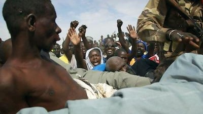 Angry crowds shout at suspected Islamist extremists in the back of an army truck in Gao, northern Mali. Mali soldiers prevented the mob from lynching them.