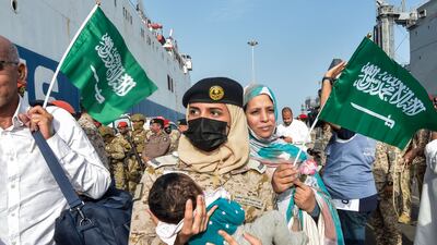 A baby is cradled by a Saudi Navy servicewoman as evacuees arrive at King Faisal Navy Base in Jeddah. AFP