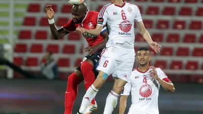 Al Ahli's Grafite, left, fight for the ball with Kim Jung Woo from Sharjah at Rashid Stadium last night. Grafite hit the game winner in the 87th minute. Jaime Puebla / The National