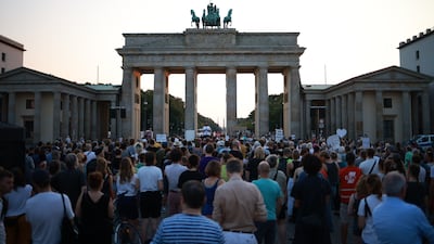 Mourners at the Brandenburg Gate commemorate victims of the ISIS-inspired knife attack in Solingen, which has sparked demands to the German government for a tougher immigration policy. EPA
