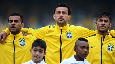 Daniel Alves and Fred singing the national anthem that strikes a strong resonance among the local fans. Buda Mendes / Getty Images
