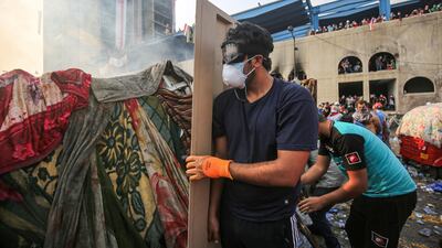 Protesters take cover behind makeshift barriers during clashes with security forces. AFP