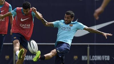 Barcelona’s Brazilian defender Dani Alves, right, and Barcelona’s forward Pedro Rodriguez, left, play with a rugby ball during a training session at the Sports Center FC Barcelona Joan Gamper in Sant Joan Despi, near Barcelona on April 15, 2014 on the eve of their Spanish Copa del Rey final football match against Real Madrid. AFP PHOTO/ LLUIS GENE