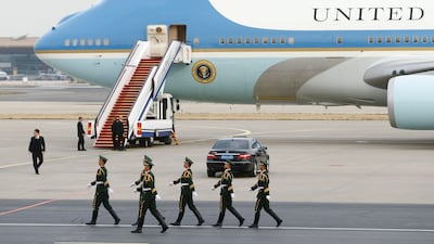US security personnel march past Air Force One after Donald Trump and his wife Melania arrived in Beijing China, on November 8, 2017.