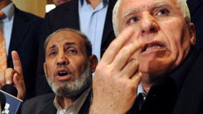 Palestinians Azzam al Ahmed, of Fatah delegation, right, and Hamas' strongman from Gaza, Mahmoud Zahar, talk during a press conference following their meeting in Cairo, Egypt.