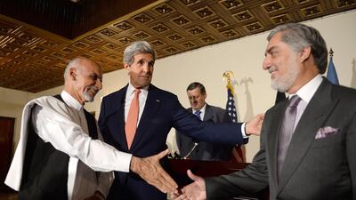 Afghan presidential candidate Ashraf Ghani, US Secretary of State John Kerry and Afghan presidential candidate Abdullah Abdullah shake hands during a joint press conference in Kabul on July 12. AFP Photo