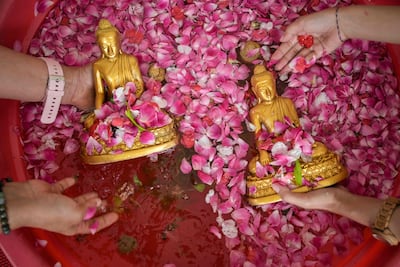 People clean Buddha statues in preparation for the Lunar New Year of the Horse at Vihara Buddhayana in Surabaya, Indonesia. AFP