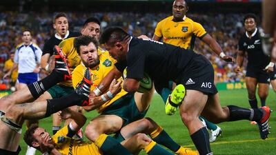 New Zealand‘s Keven Mealamu, right, runs with the ball against Australia during their Bledisloe Cup match in Brisbane on Saturday. Patrick Hamilton / AFP